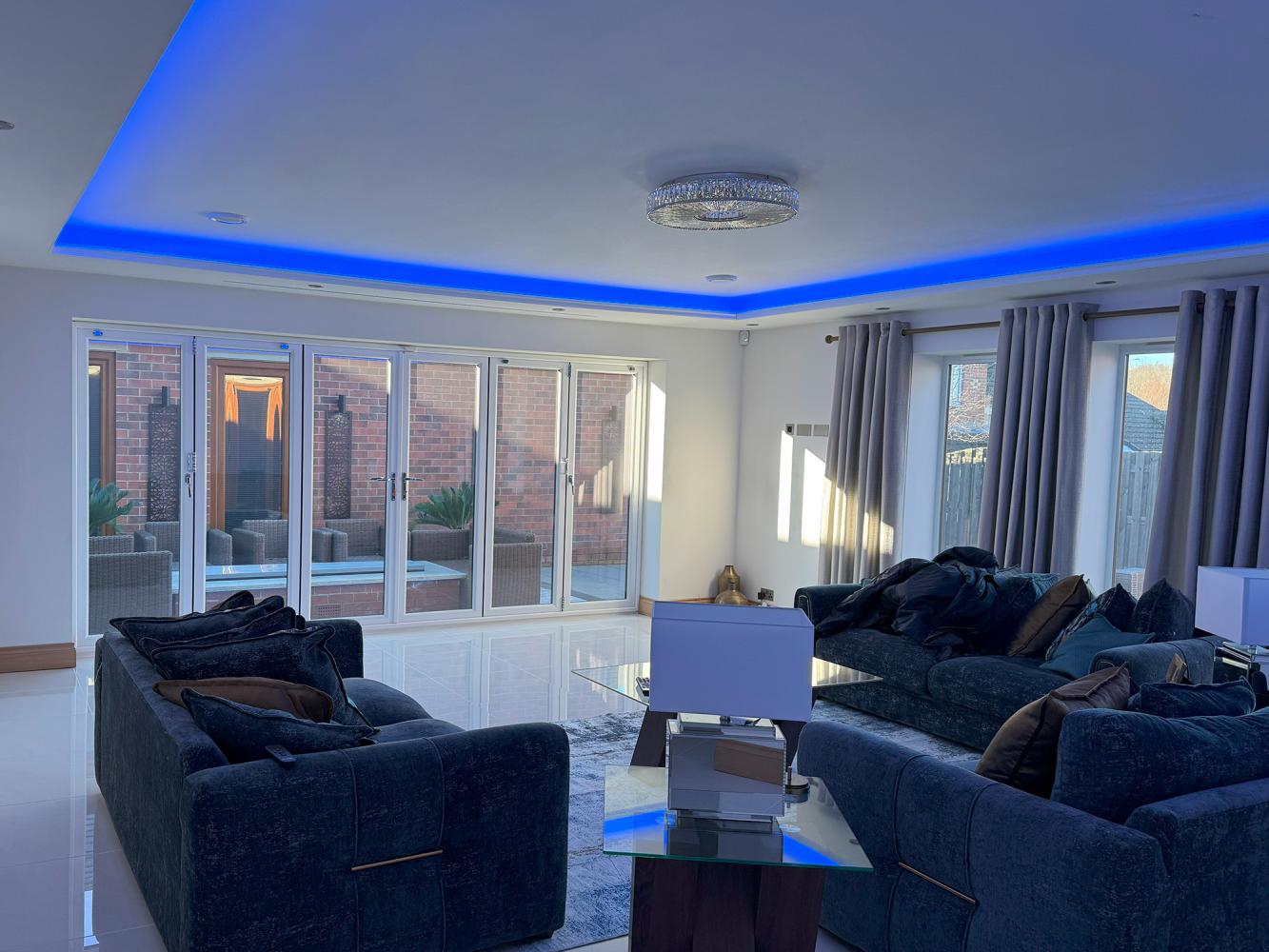 Bifold Doors in living room with hidden home cinema