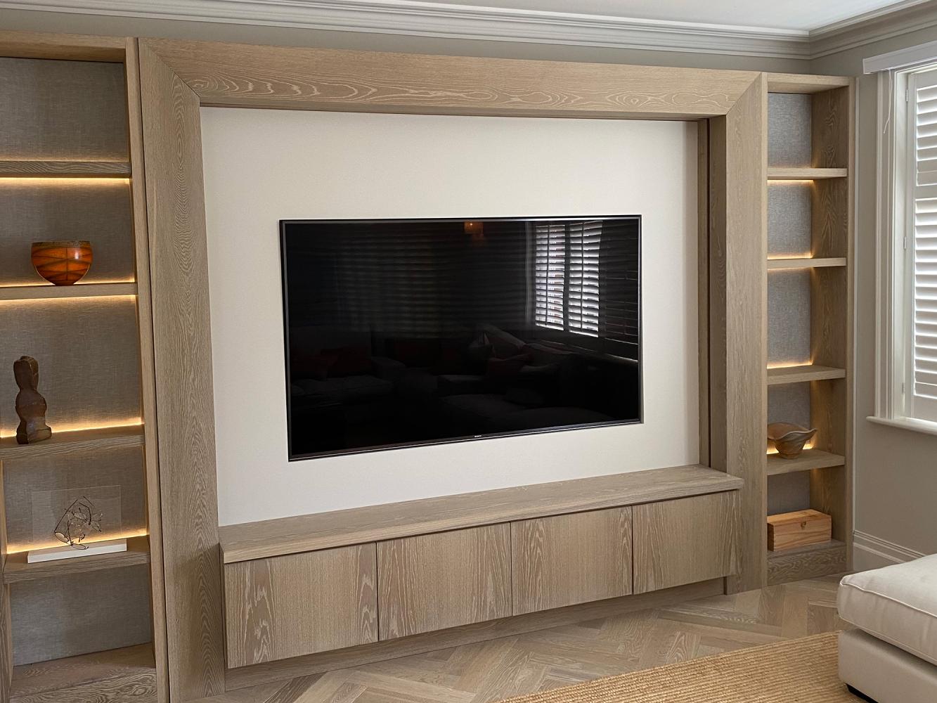 TV on media wall with cabinetry below