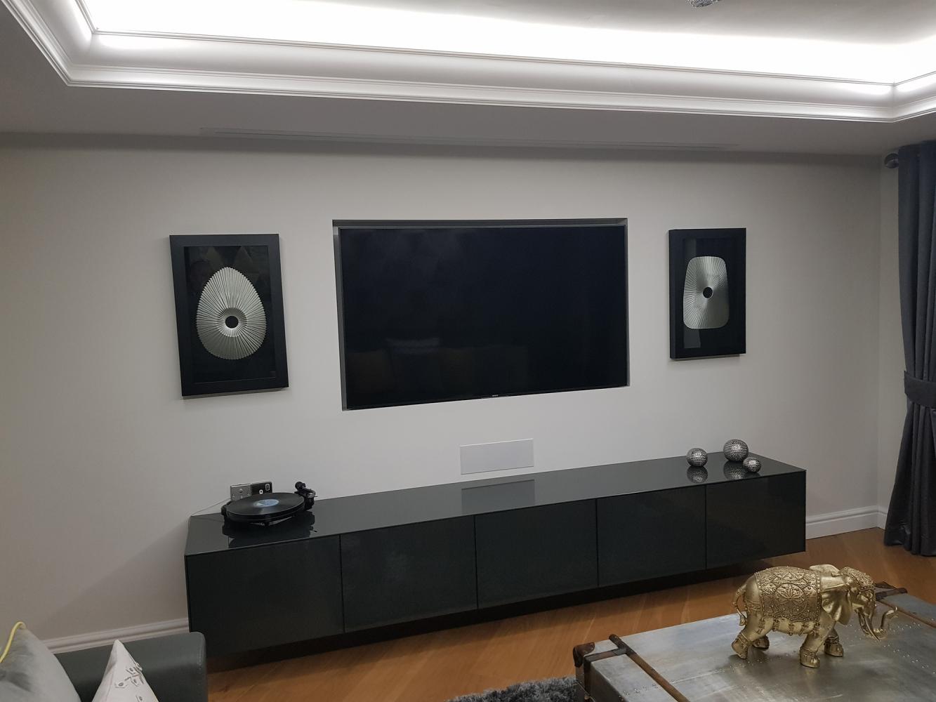 TV on media wall with cabinetry below