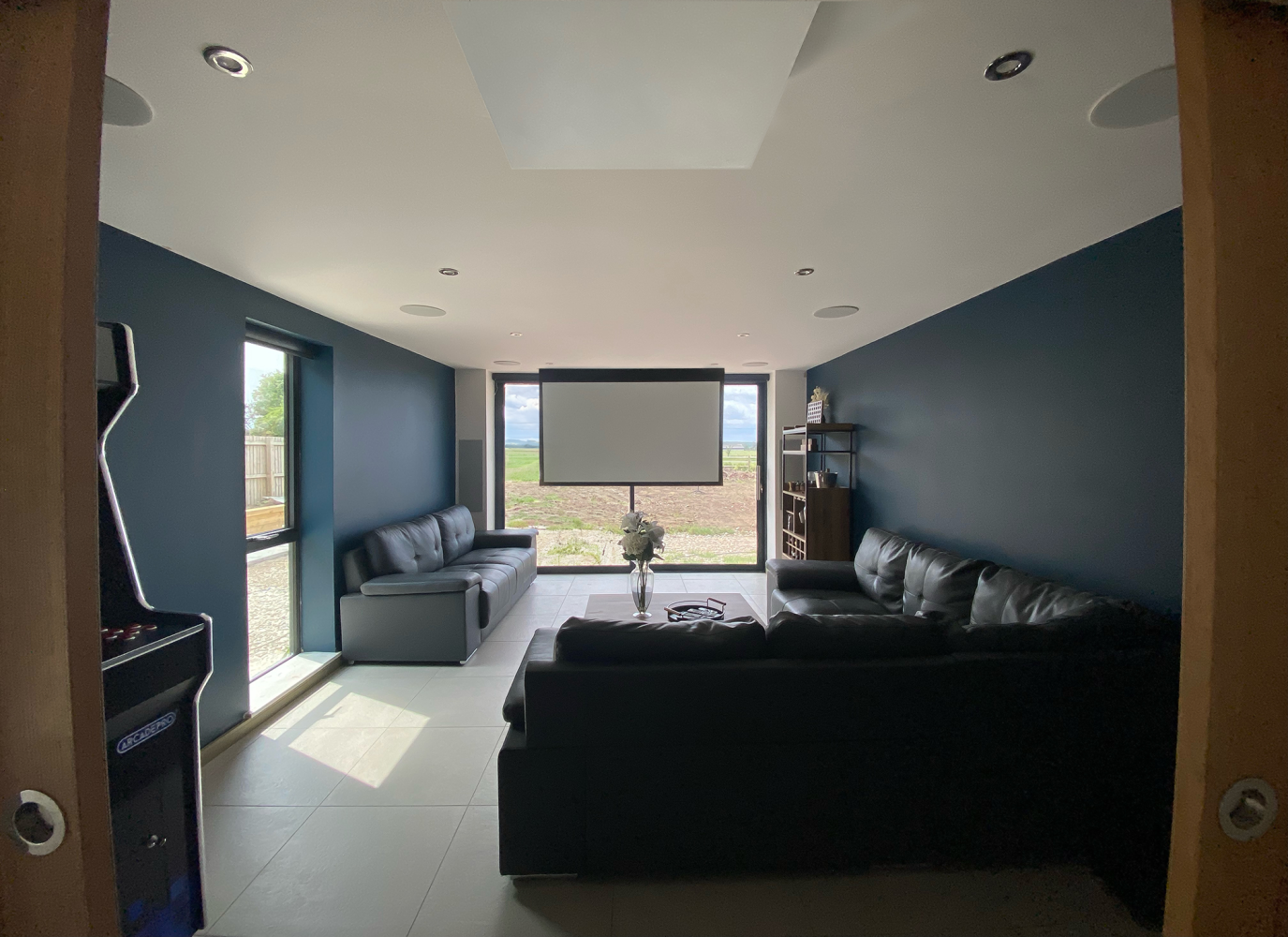 projector screen coming down in front of bifold doors
