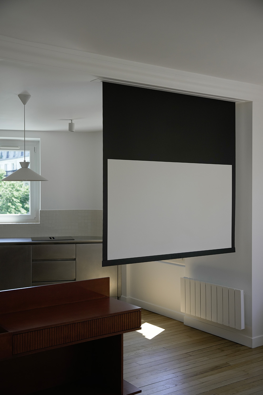 Ceiling recessed Projector screen down inbetween living room and kitchen